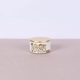 Small white round concrete box with graffiti in copper and gold leaf lid - Fastoun